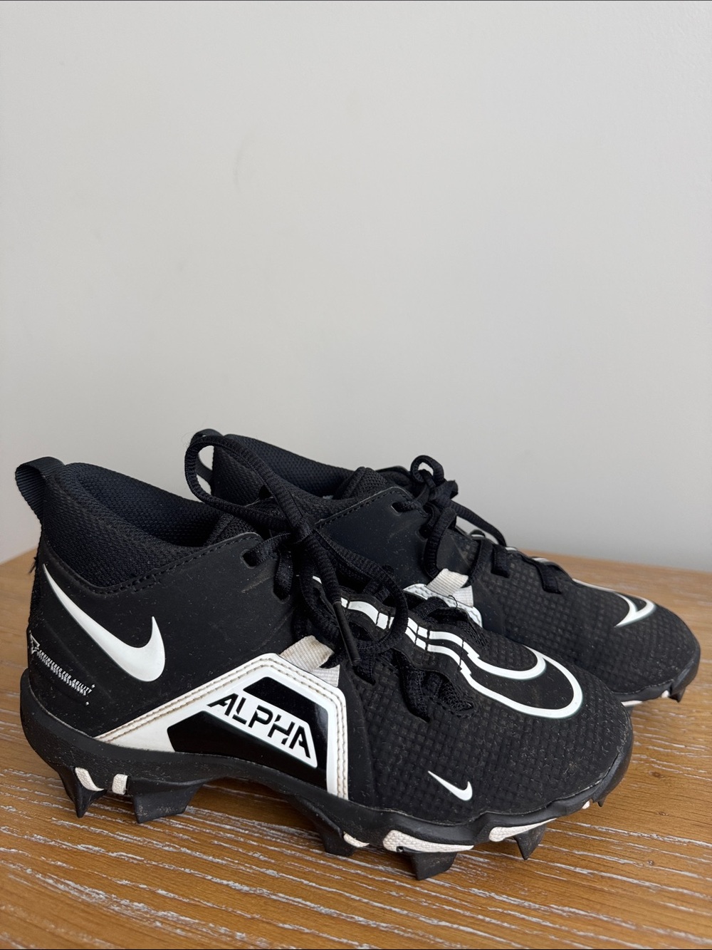 Nike Black and White Kids Alpha Cleat Sneakers